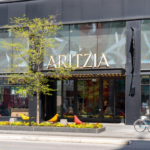 Exterior of an Aritzia fashion boutique with the brand's sign above the entrance.
