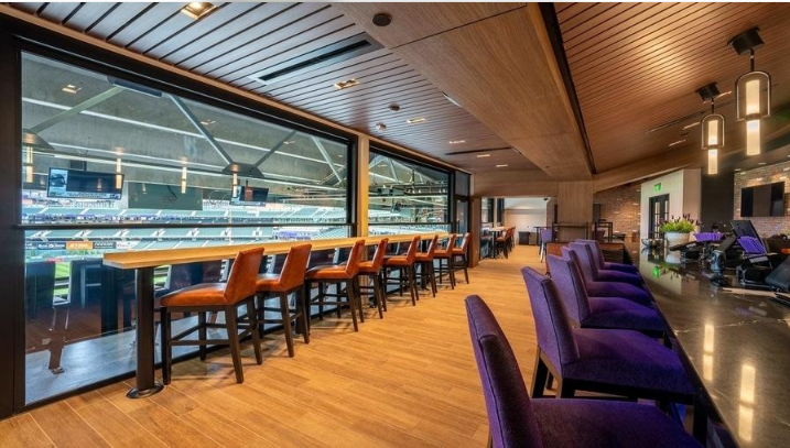 Stadium hospitality lounge overlooking a football pitch