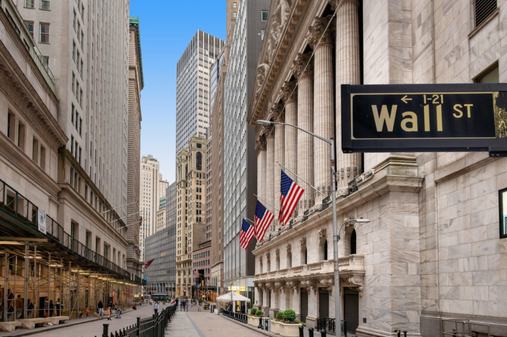 Wall Street sign overlooking the financial district in Lower Manhattan, New York City.