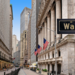 Wall Street sign overlooking the financial district in Lower Manhattan, New York City.