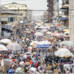 Shoppers and traders at a busy urban marketplace in Africa.