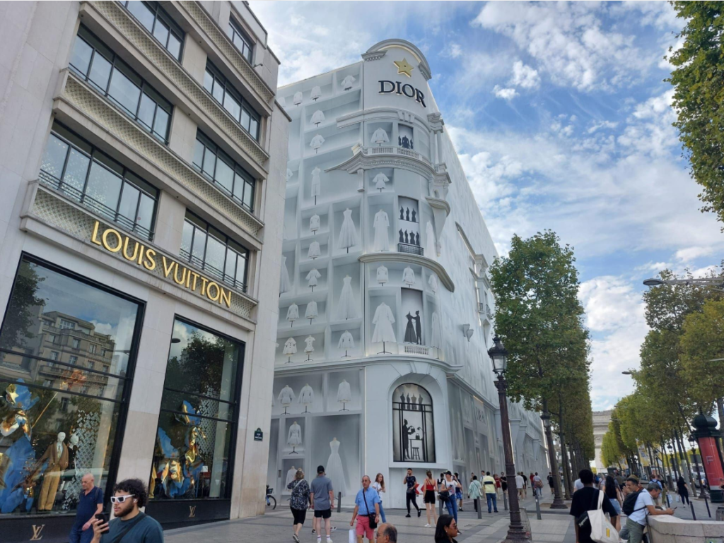 Luxury fashion boutiques along an upscale shopping street in Paris.