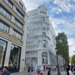 Luxury fashion boutiques along an upscale shopping street in Paris.