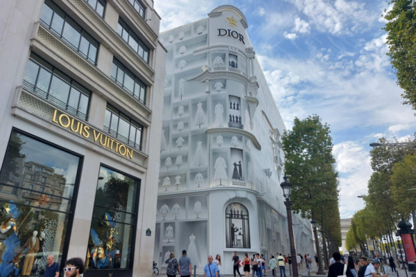 Luxury fashion boutiques along an upscale shopping street in Paris.