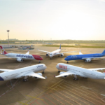Commercial passenger aircraft parked at a busy international airport.