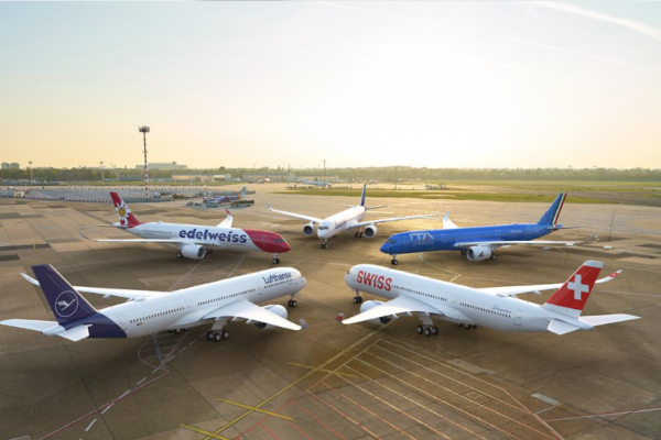 Commercial passenger aircraft parked at a busy international airport.