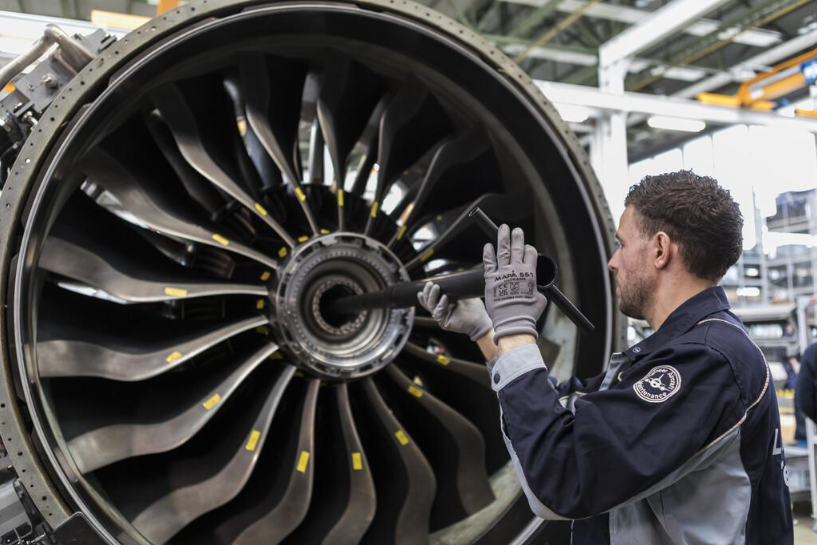 Close-up of a commercial passenger aircraft engine during airport ground operations.