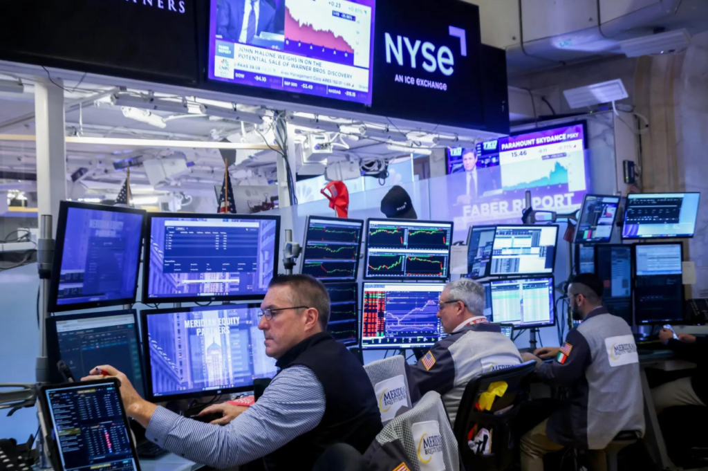 Traders and financial market screens on the New York Stock Exchange trading floor.