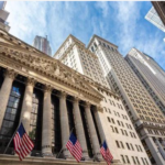 Exterior of the New York Stock Exchange building with American flags.
