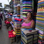 Traders and small business owners operating in a busy African commercial market.