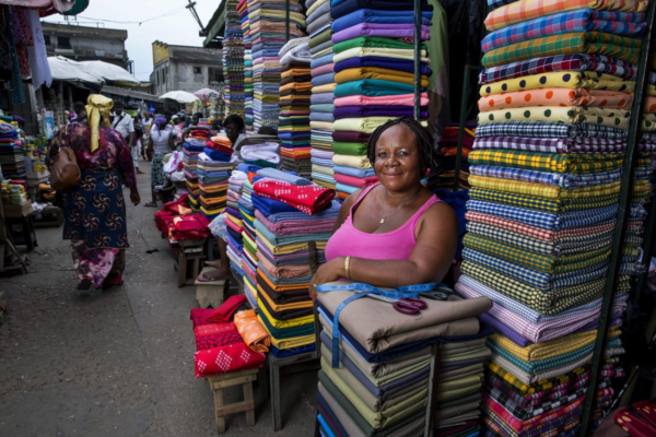 Traders and small business owners operating in a busy African commercial market.