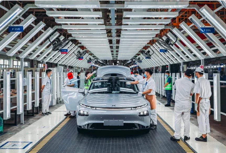 Vehicles undergoing assembly on a production line at a Chinese automobile factory.
