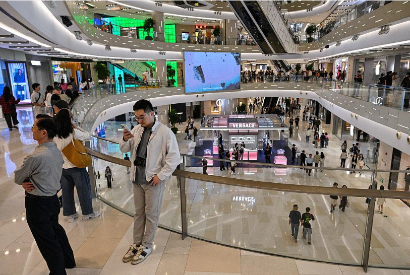 Shoppers walking through a retail shopping centre in Shanghai.