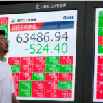 Electronic stock market display showing Japanese share prices.
