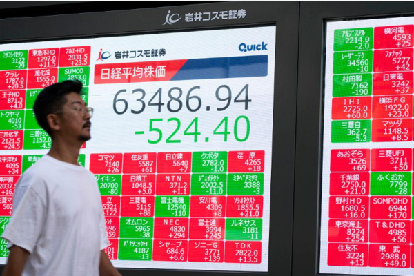 Electronic stock market display showing Japanese share prices.