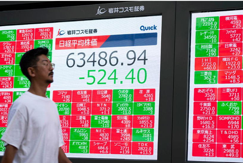Electronic stock market display showing Japanese share prices.