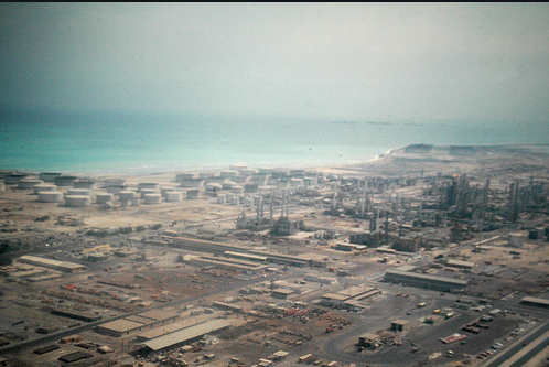 Aerial view of oil storage tanks and refinery infrastructure at Ras Tanura, Saudi Arabia.