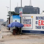 Street advertisement promoting the Dangote Petroleum Refinery IPO in Nigeria, with the message “Buying a share is easier than you think.”