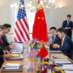 : American and Chinese flags displayed during an official diplomatic meeting.