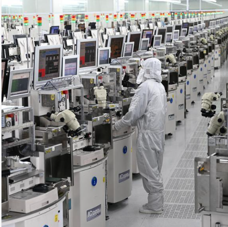 Semiconductor manufacturing equipment inside an industrial cleanroom.