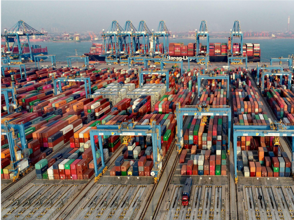 Shipping containers and cargo cranes at an international port.