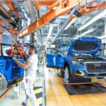Audi vehicles on an automotive manufacturing assembly line.