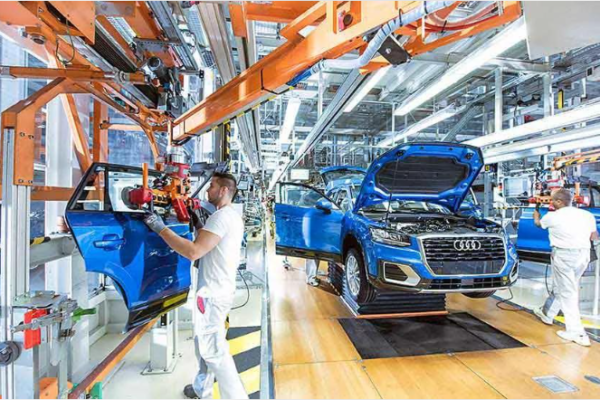 Audi vehicles on an automotive manufacturing assembly line.