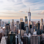 Manhattan's financial district skyline with office towers overlooking the waterfront.