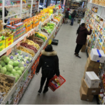Grocery store aisle displaying fresh produce and packaged food products
