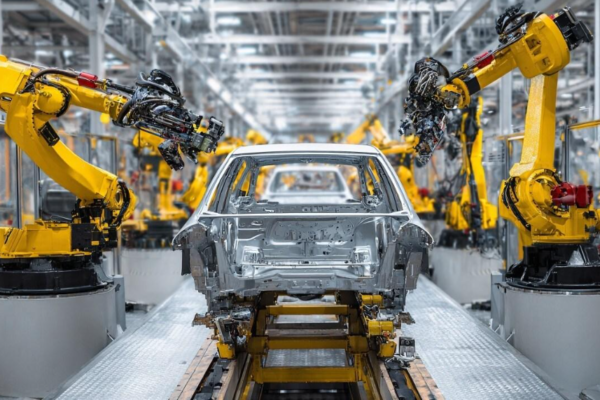 Robotic arms assembling a car chassis on an automotive production line