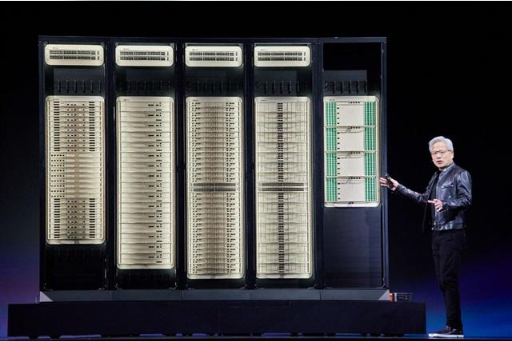 Jensen Huang signing a computing board while surrounded by attendees at a technology exhibition.